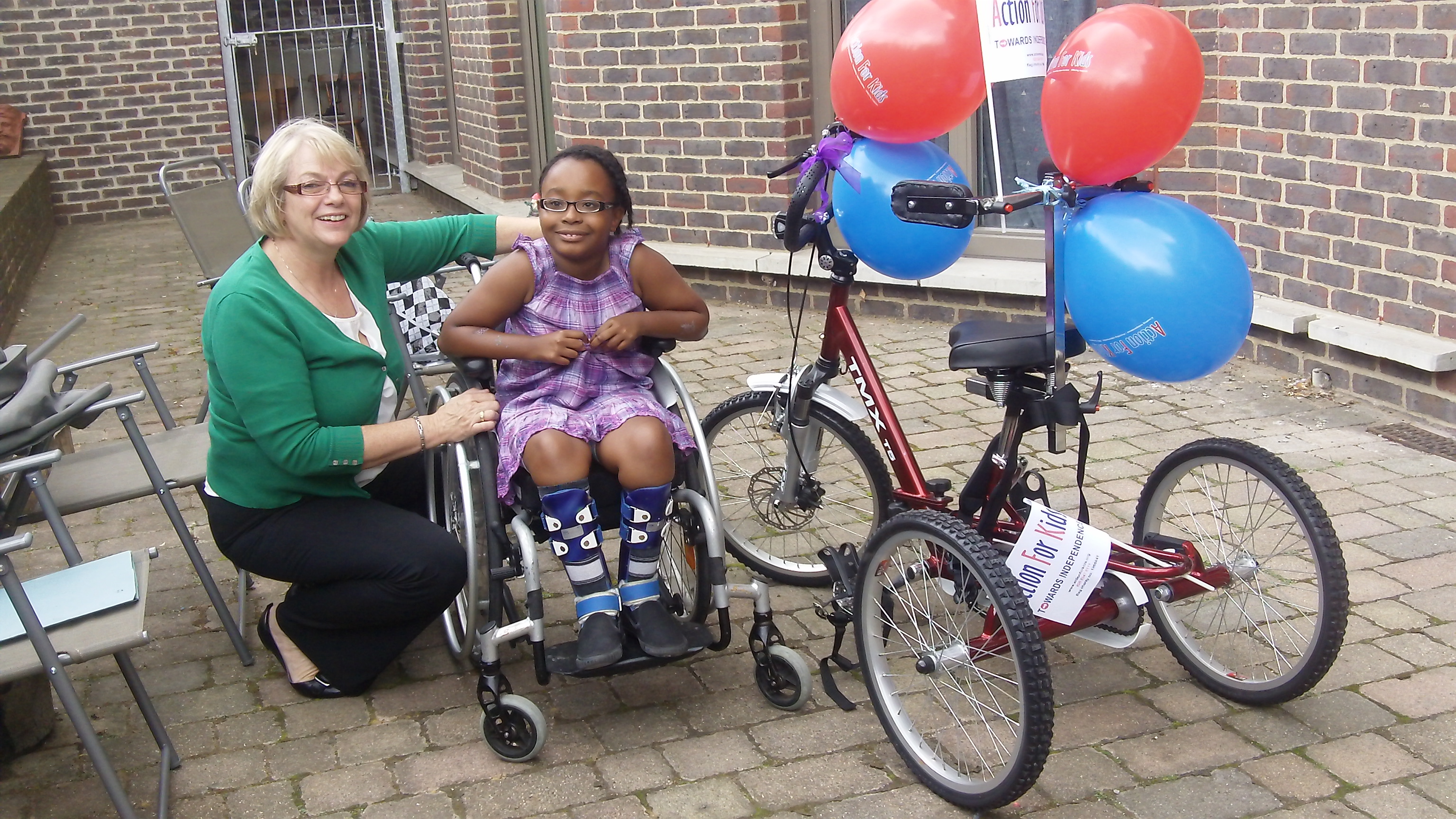 Sally Bishop and young person in wheelchair