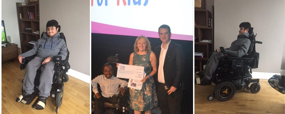 Cheque handover and person showing mobility wheelchair