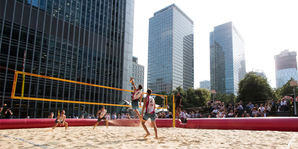 Beach volleyball with city skyscrapers in the background