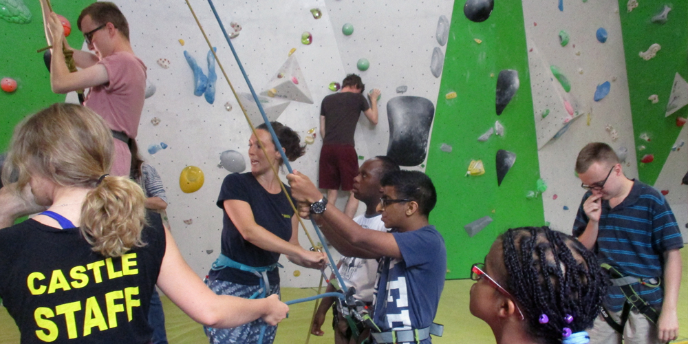 Disabled teens learning to climb and abseil