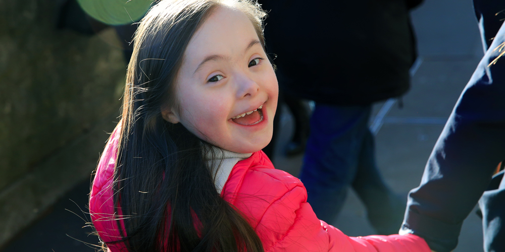 Smiling little girl with Down syndrome