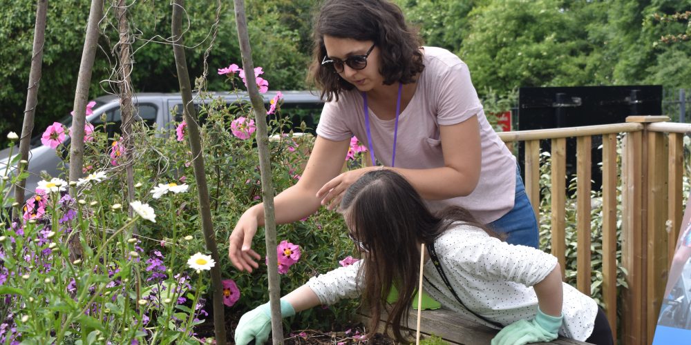 AFK staff member Hana and a young girl with Down Syndrome in our Edible Garden