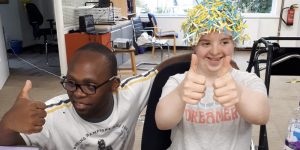 Two young people with learning disabilities giving thumbs up